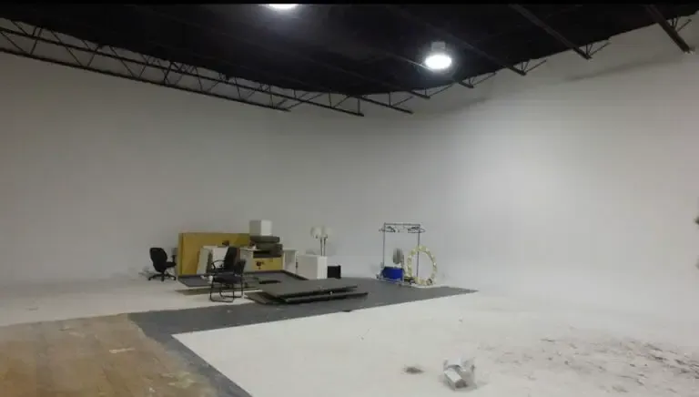 Studio 1 before the build, a bare white room with a table and chairs