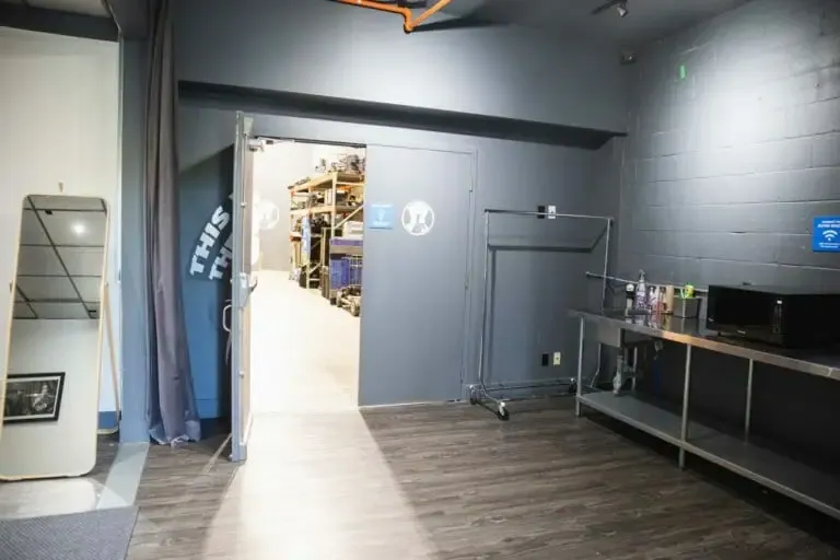 The support room after, a mirror, a wardrobe rail and a counter, shelving beyond the door