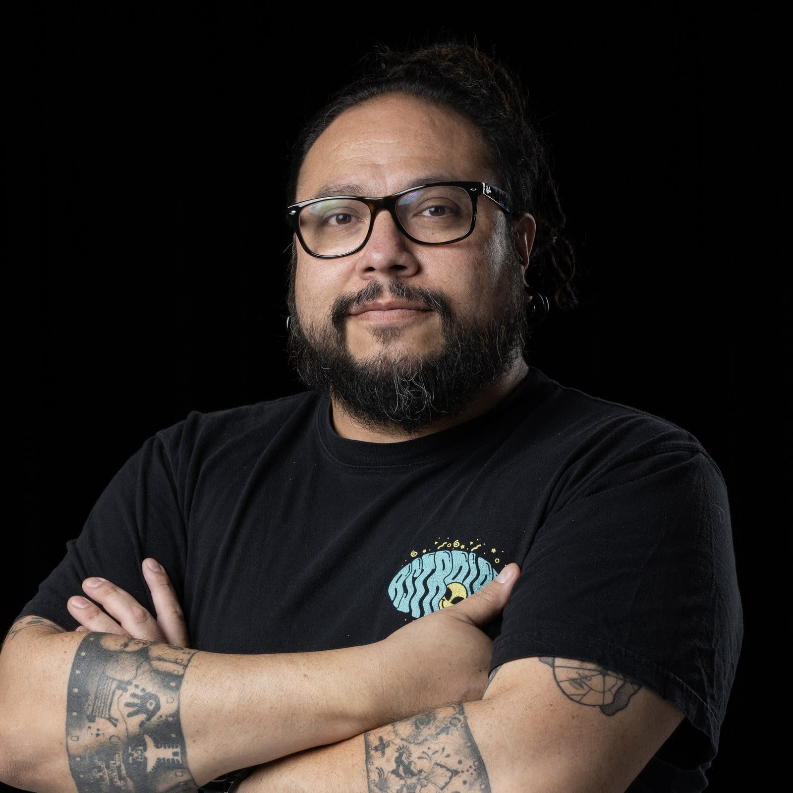 Portrait of German Prieto, arms folded, in an AstroLab T-shirt