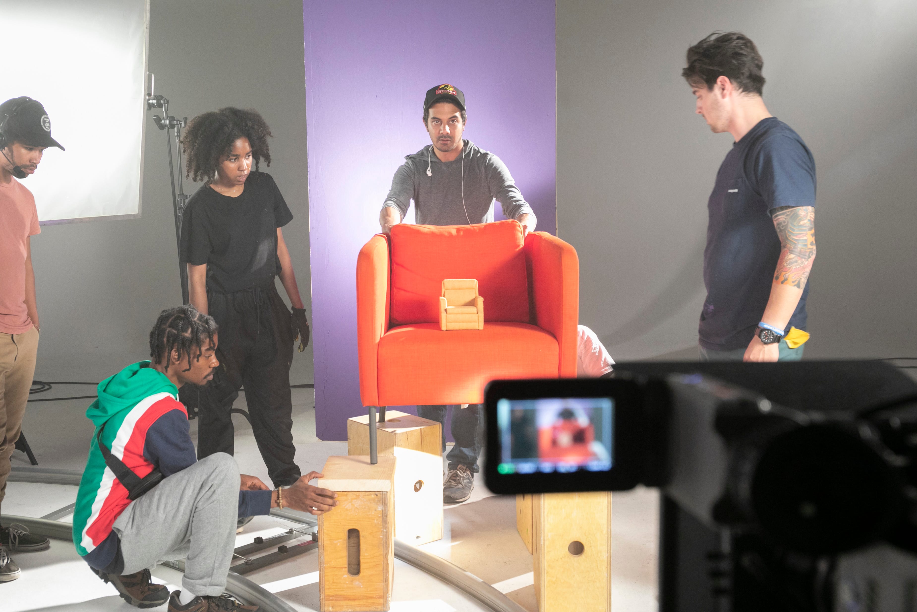 A youth film program crew setting up a shot together on the stage