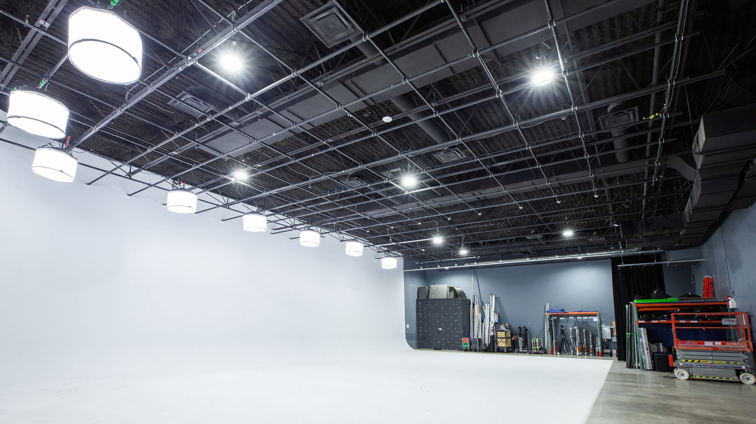 The white cyc running the length of the stage under the black ceiling grid